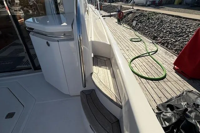 Jesse James Yacht Photos Pics 2011 Tiara Yachts 5800 Sovran deck with wooden steps and outdoor equipment.