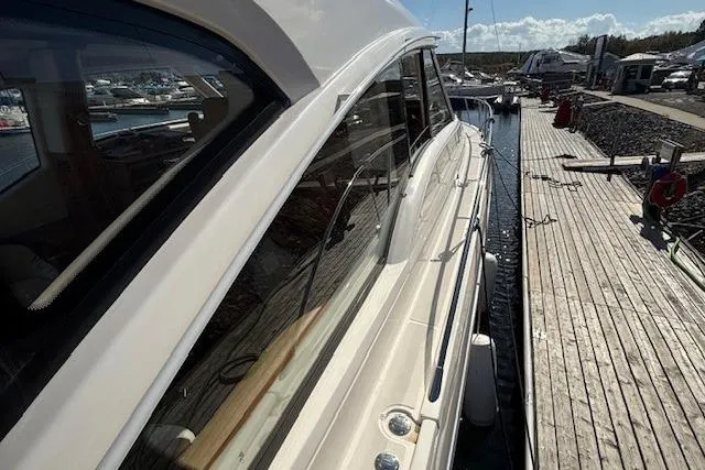 Jesse James Yacht Photos Pics 2011 Tiara Yachts 5800 Sovran docked at marina, side view.