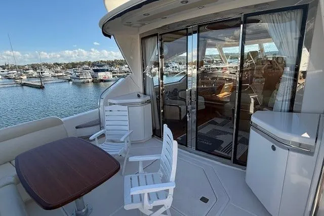 Jesse James Yacht Photos Pics 2011 Tiara Yachts 5800 Sovran with outdoor seating, docked at a marina.