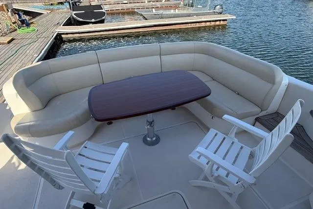 Jesse James Yacht Photos Pics 2011 Tiara Yachts 5800 Sovran deck with seating and table by the water.