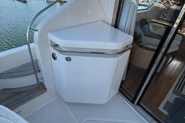 Jesse James Yacht Photos Pics 2011 Tiara Yachts 5800 Sovran yacht interior with sleek white cabinetry and wooden flooring.