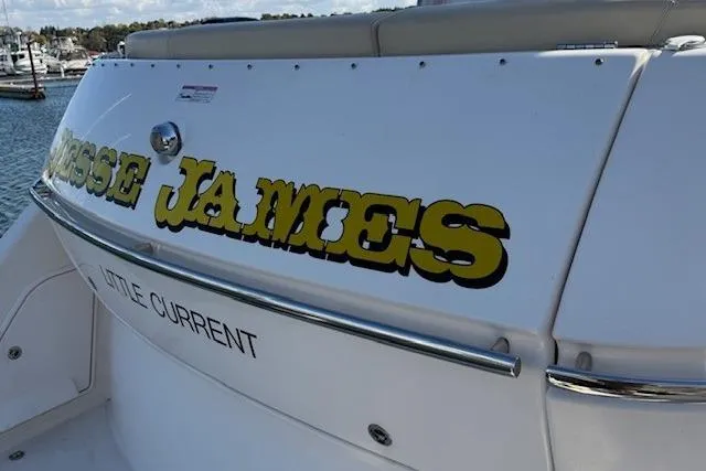 Jesse James Yacht Photos Pics 2011 Tiara Yachts 5800 Sovran with "Jesse James" lettering, docked at a marina.
