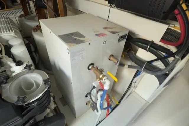 Jesse James Yacht Photos Pics Engine room of 2011 Tiara Yachts 5800 Sovran, featuring mechanical components and wiring.