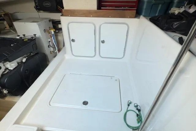 Jesse James Yacht Photos Pics Engine room of 2011 Tiara Yachts 5800 Sovran with storage compartments and equipment.