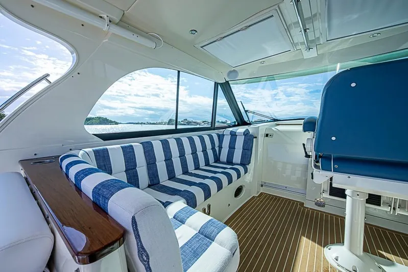 Catnap Yacht Photos Pics Interior of 2023 Hinckley Sport Boat 40 X with striped seating and scenic view.