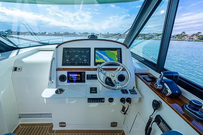 Catnap Yacht Photos Pics 2023 Hinckley Sport Boat 40 X helm with advanced navigation system and scenic water view.