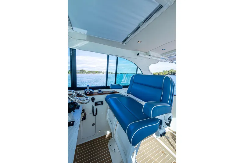 Catnap Yacht Photos Pics Interior of 2023 Hinckley Sport Boat 40 X with blue seating and scenic water view.