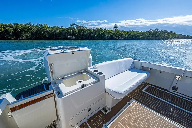 Catnap Yacht Photos Pics 2023 Hinckley Sport Boat 40 X, featuring a sleek deck and comfortable seating by the water.