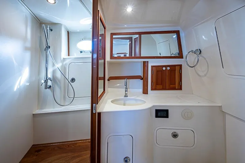 Catnap Yacht Photos Pics Luxurious bathroom interior of 2023 Hinckley Sport Boat 40 X with shower and sink.