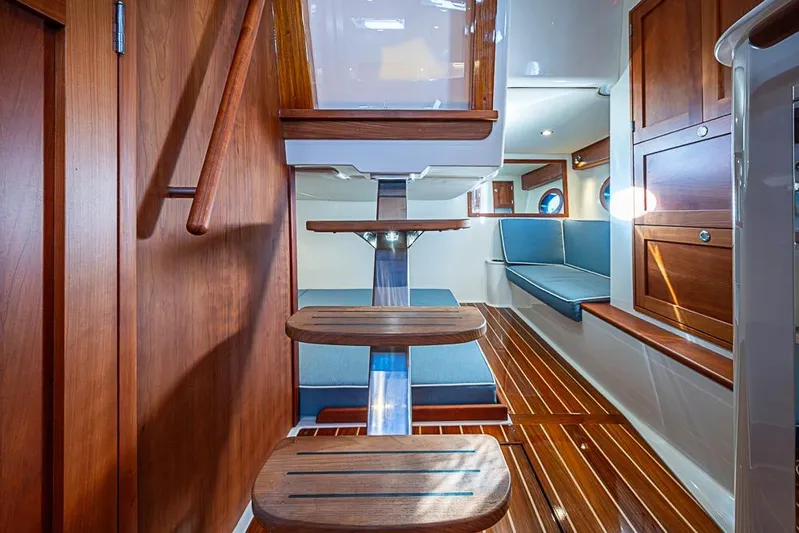 Catnap Yacht Photos Pics 2023 Hinckley Sport Boat 40 X interior with wooden finishes and blue seating.