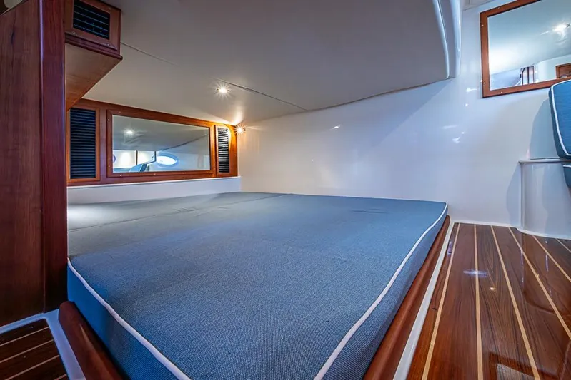 Catnap Yacht Photos Pics 2023 Hinckley Sport Boat 40 X cabin interior with blue bedding and wooden accents.