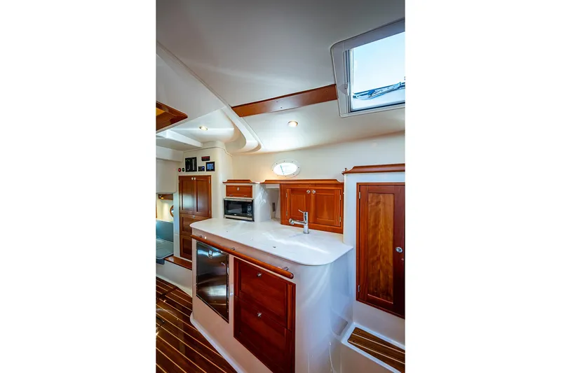 Catnap Yacht Photos Pics Luxurious interior of 2023 Hinckley Sport Boat 40 X with wooden cabinetry and modern amenities.