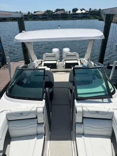  Yacht Photos Pics 2024 Regal 29 boat with sleek design, docked by a serene waterfront.