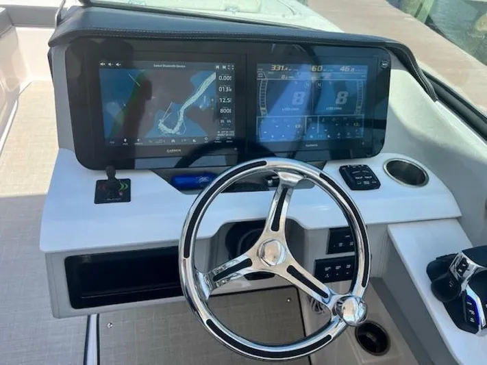  Yacht Photos Pics 2024 Regal 29 boat dashboard with navigation screens and steering wheel.