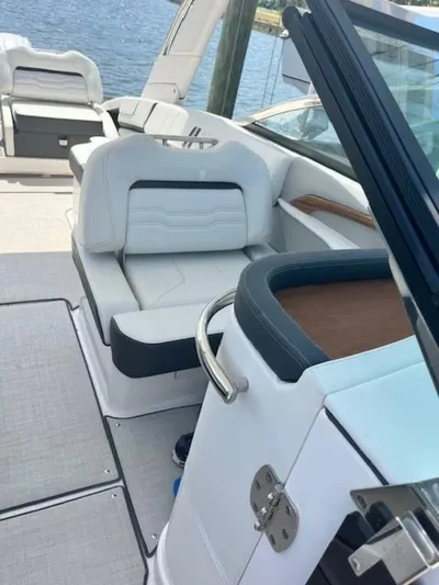  Yacht Photos Pics 2024 Regal 29 boat interior with white seating and sleek design.