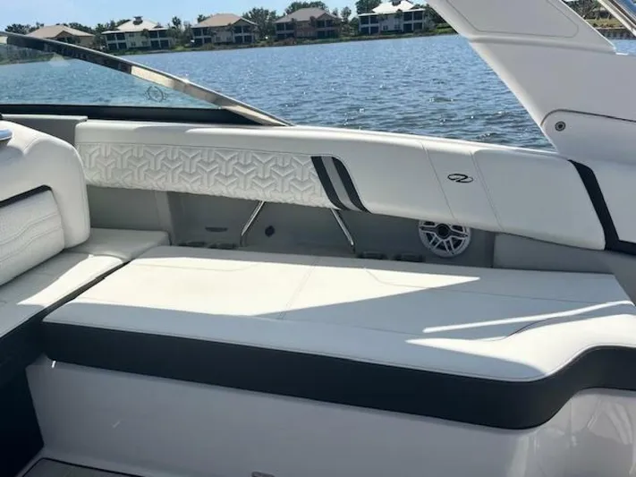  Yacht Photos Pics 2024 Regal 29 boat interior with white seating, lake view, and modern design.