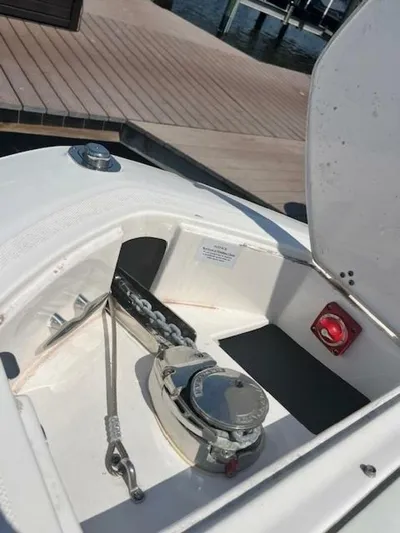  Yacht Photos Pics 2024 Regal 29 boat anchor compartment with winch and chain at dock.