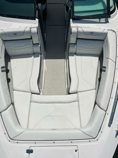  Yacht Photos Pics 2024 Regal 29 boat interior with white cushioned seating and sleek design.