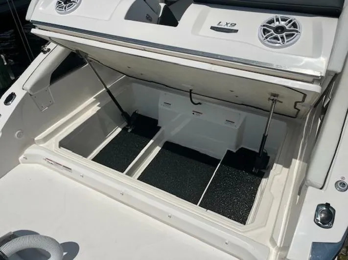  Yacht Photos Pics 2024 Regal 29 boat storage compartment with open hatch and speakers.