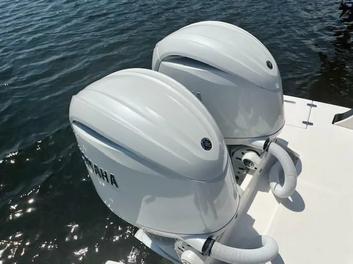 Yacht Photos Pics Twin Yamaha outboard engines on a 2024 Regal 29 boat, docked on water.