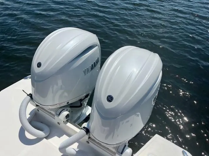  Yacht Photos Pics Twin outboard motors on a 2024 Regal 29 boat, floating on calm water.