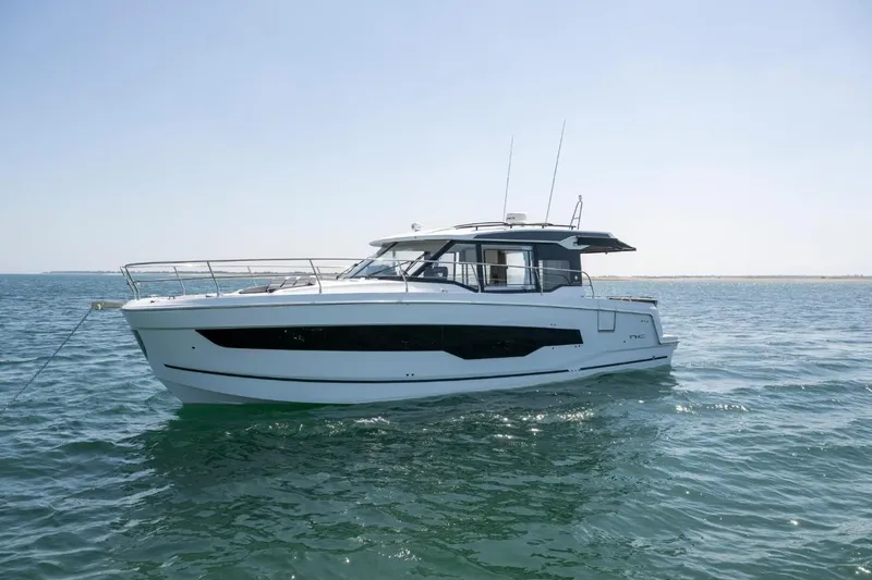  Yacht Photos Pics 2026 Jeanneau NC 1295 Weekender yacht on calm ocean waters.