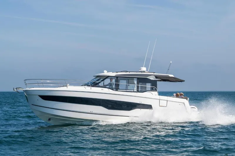  Yacht Photos Pics 2026 Jeanneau NC 1295 Weekender cruising on open water under clear skies.