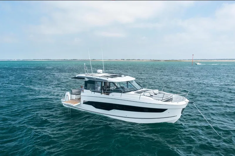  Yacht Photos Pics 2026 Jeanneau NC 1295 Weekender yacht on open water, clear sky background.