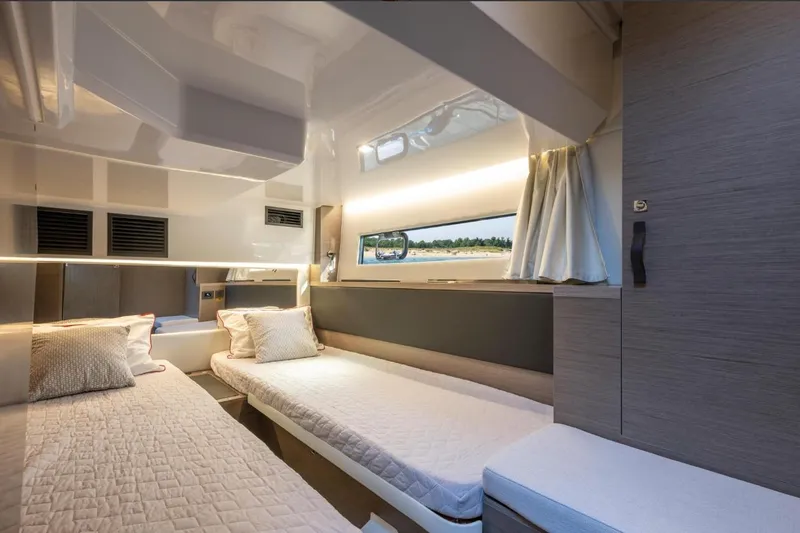  Yacht Photos Pics Interior cabin of 2026 Jeanneau NC 1295 Weekender with twin beds and modern design.