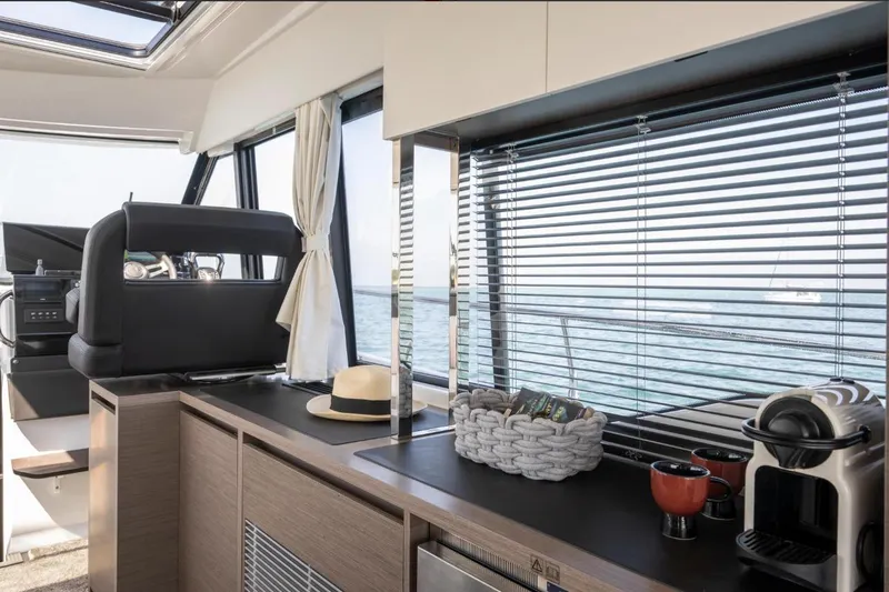  Yacht Photos Pics Interior of 2026 Jeanneau NC 1295 Weekender with modern kitchen and sea view.