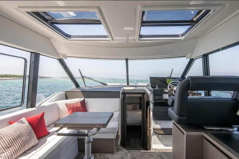  Yacht Photos Pics Interior of 2026 Jeanneau NC 1295 Weekender yacht with modern seating and panoramic windows.