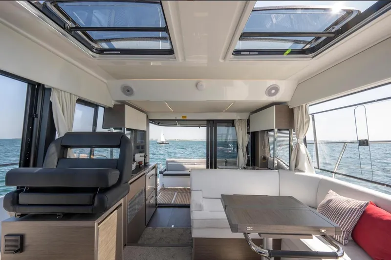  Yacht Photos Pics Interior of 2026 Jeanneau NC 1295 Weekender yacht with modern seating and ocean view.