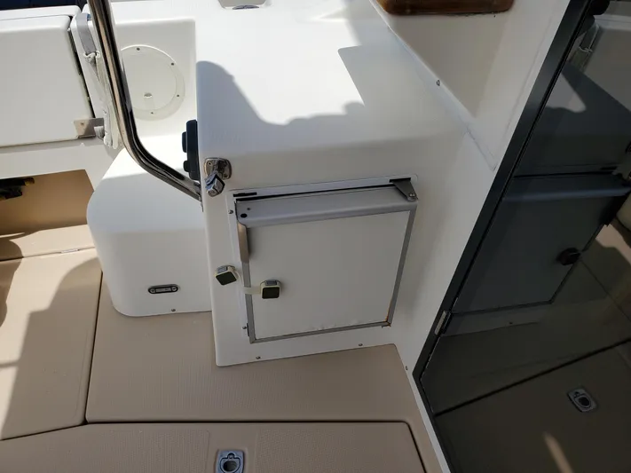  Yacht Photos Pics 2016 Cutwater 30 Command Bridge interior detail with storage compartment.