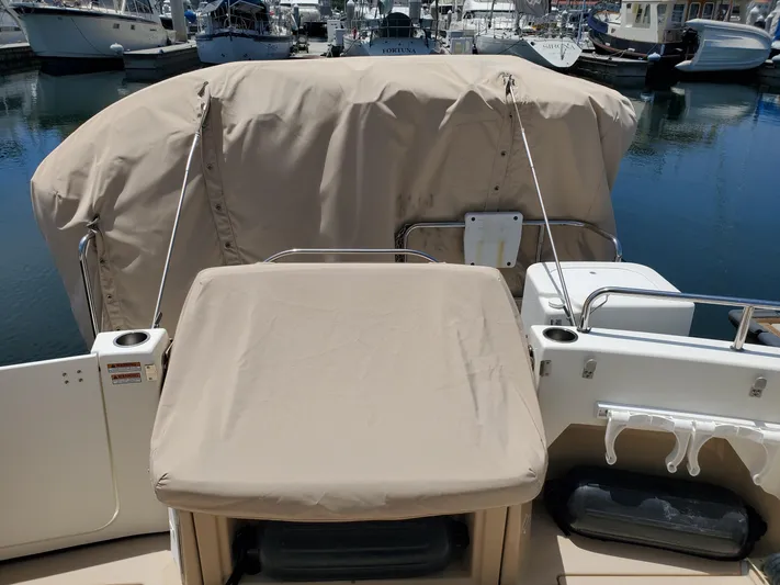  Yacht Photos Pics 2016 Cutwater 30 Command Bridge boat with covered seating, docked in a marina.