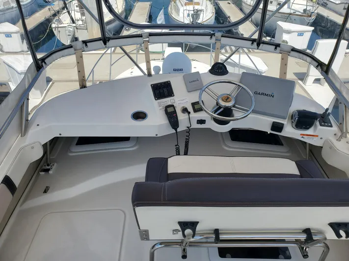  Yacht Photos Pics 2016 Cutwater 30 Command Bridge helm with Garmin navigation system and marina view.