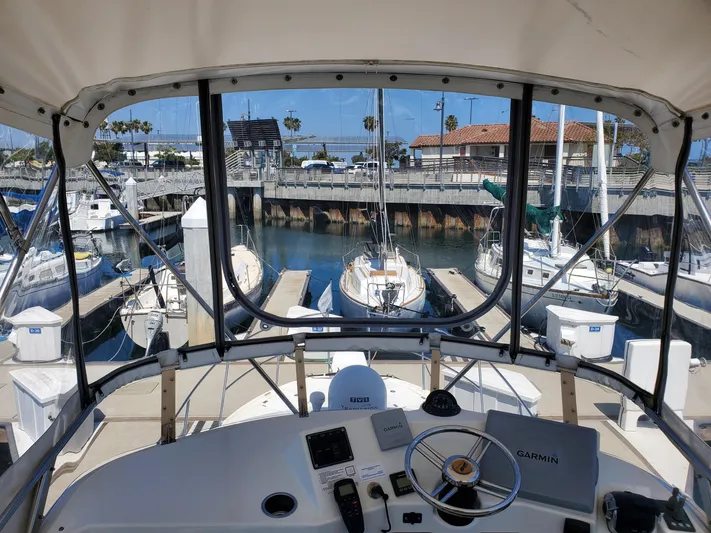  Yacht Photos Pics View from 2016 Cutwater 30 Command Bridge at marina, showcasing helm and docked boats.