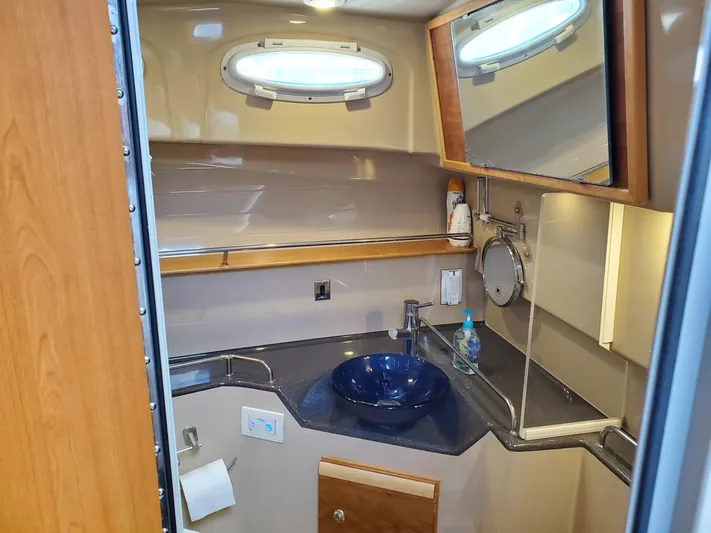  Yacht Photos Pics 2016 Cutwater 30 Command Bridge bathroom with modern sink and mirror.