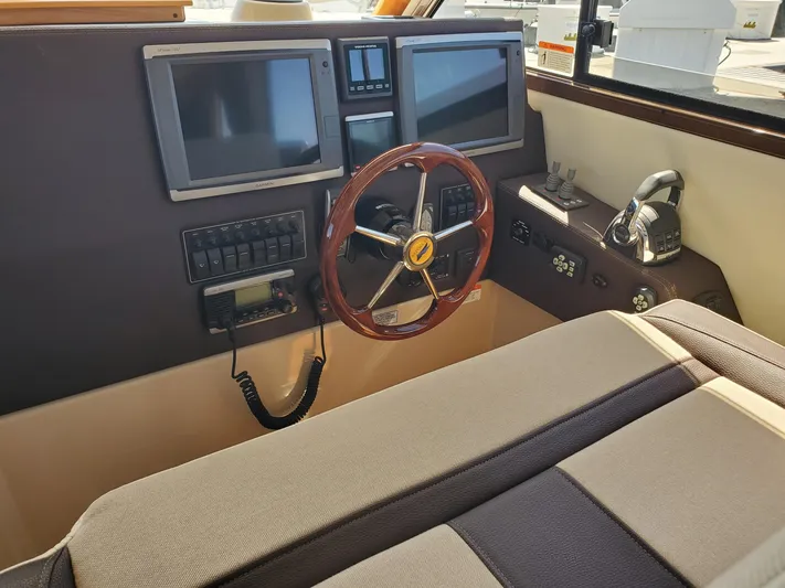  Yacht Photos Pics 2016 Cutwater 30 Command Bridge helm with dual screens and wooden steering wheel.