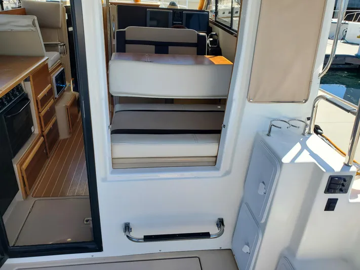  Yacht Photos Pics Interior view of 2016 Cutwater 30 Command Bridge boat, featuring seating and kitchen area.