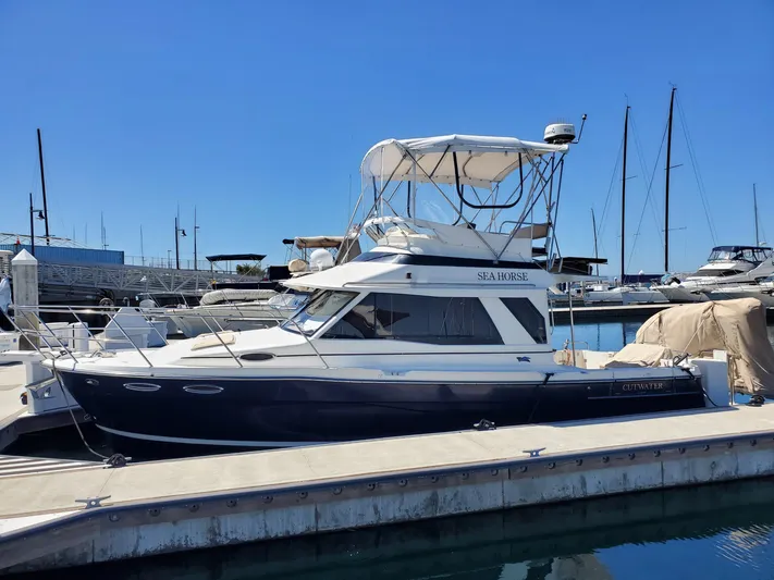  Yacht Photos Pics 2016 Cutwater 30 Command Bridge yacht docked at marina under clear blue sky.