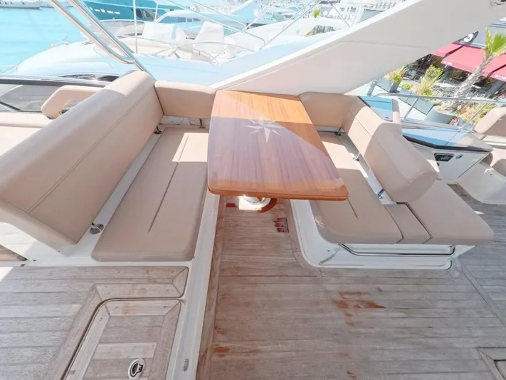  Yacht Photos Pics Luxurious seating area on 2016 Sea Ray L650 Fly yacht with wooden table.