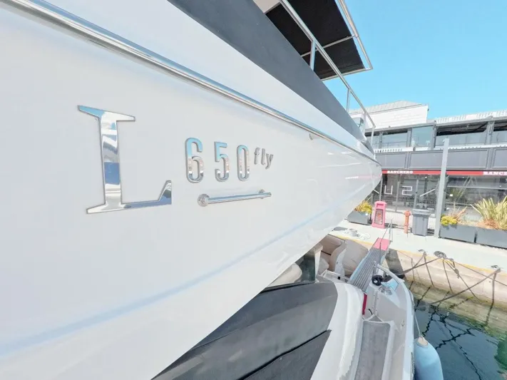  Yacht Photos Pics 2016 Sea Ray L650 Fly yacht docked at marina, showcasing sleek design and branding.