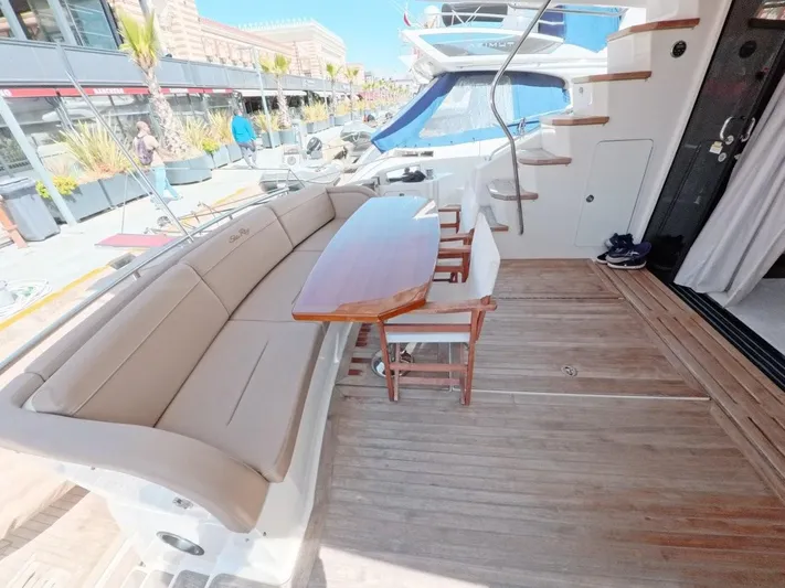  Yacht Photos Pics 2016 Sea Ray L650 Fly yacht deck with seating and table, docked at marina.