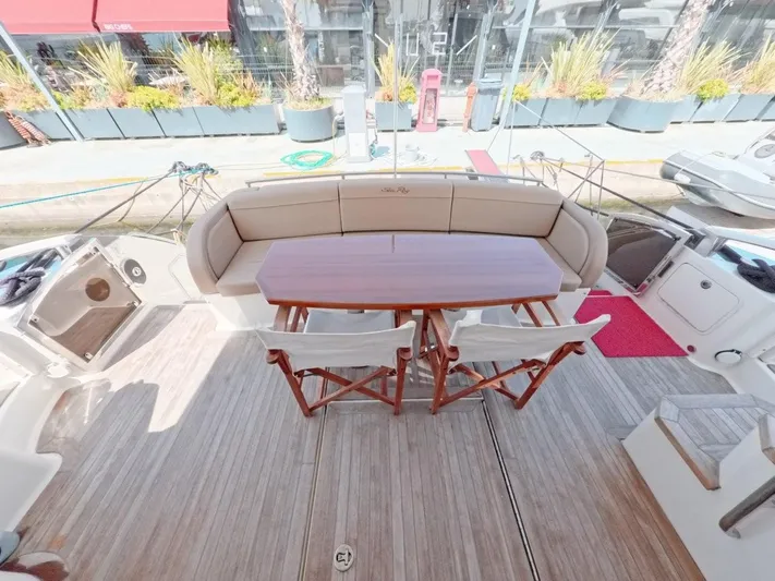  Yacht Photos Pics 2016 Sea Ray L650 Fly yacht deck with seating and wooden table.