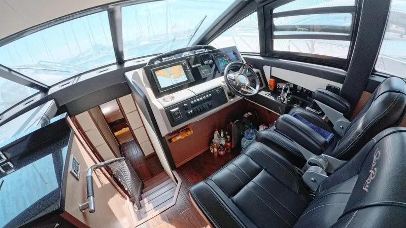  Yacht Photos Pics 2016 Sea Ray L650 Flybridge cockpit with modern controls and luxurious seating.