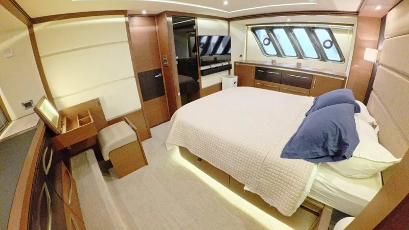  Yacht Photos Pics Luxurious bedroom interior of 2016 Sea Ray L650 Fly yacht with modern furnishings.