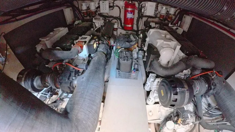  Yacht Photos Pics Engine room of 2016 Sea Ray L650 Fly yacht, showcasing dual engines and fire extinguisher.