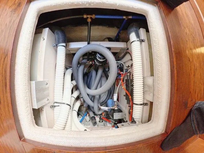  Yacht Photos Pics Engine compartment of 2016 Sea Ray L650 Fly yacht, showcasing intricate wiring and hoses.
