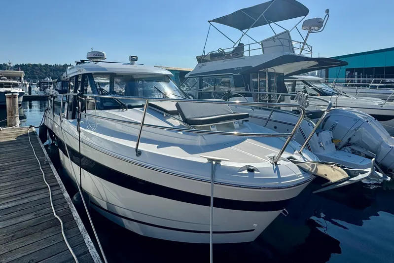 Shanty Town Yacht Photos Pics 2020 Jeanneau NC 895 boat docked at a marina under clear blue skies.