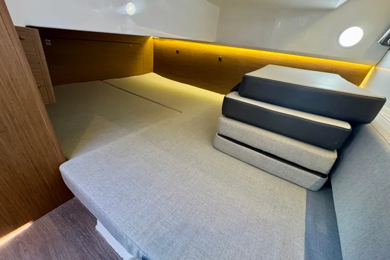 Shanty Town Yacht Photos Pics Interior cabin of 2020 Jeanneau NC 895 boat with cushions and ambient lighting.